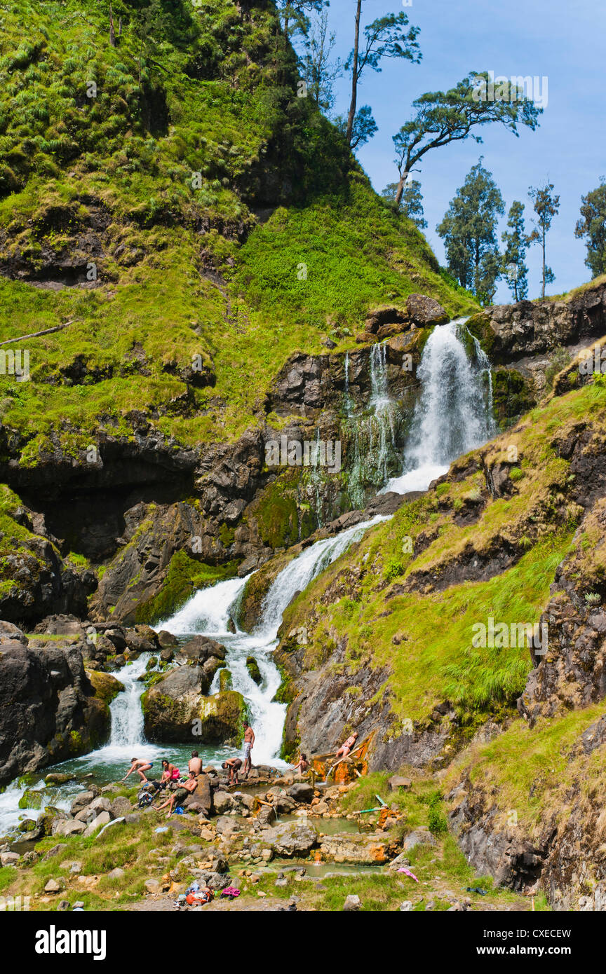 Tourists swimming in hot pools and waterfalls on Mount Rinjani volcano crater, Lombok, Indonesia, Southeast Asia, Asia Stock Photo