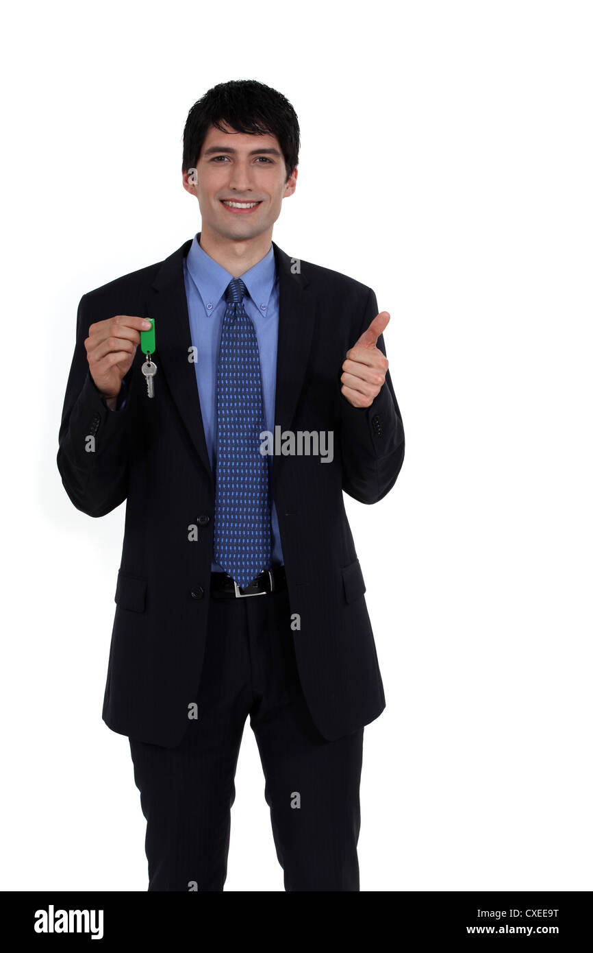 businessman holding a key Stock Photo - Alamy