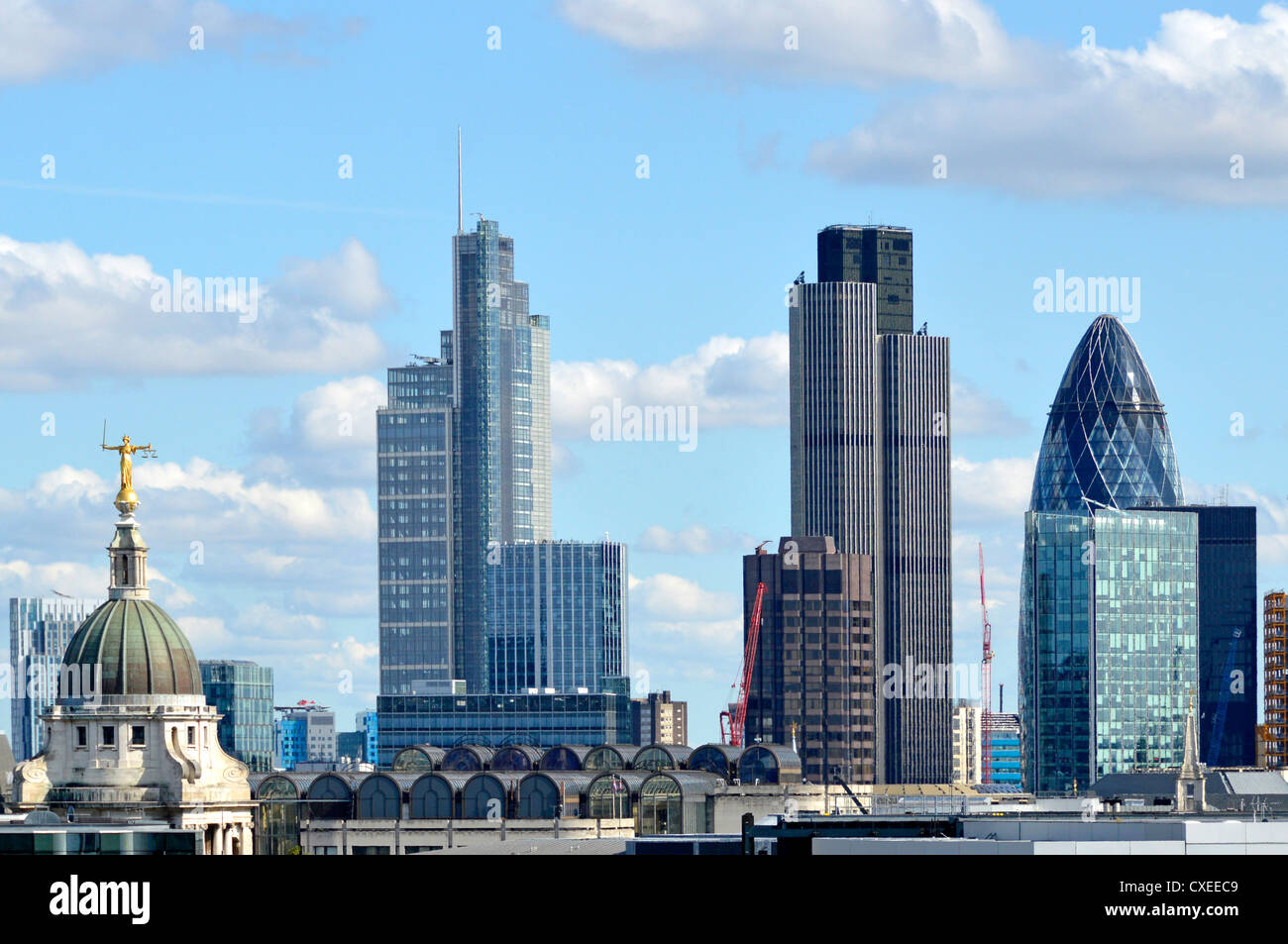 City of London ancient and modern buildings on urban landscape skyline including Old Bailey Heron Tower, Tower 42, and the Gherkin England UK Stock Photo