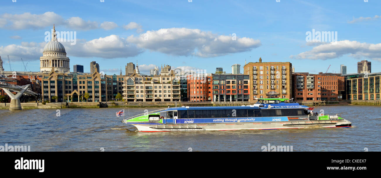 Thames Clipper riverboat commuter and tourist service passing St Pauls cathedral carrying KPMG advertising Stock Photo