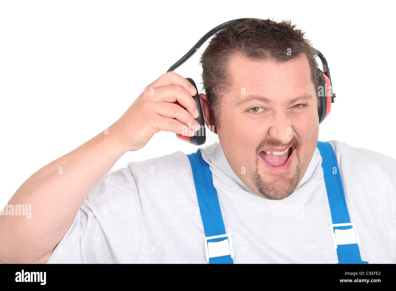 Workman disturbed by noise Stock Photo