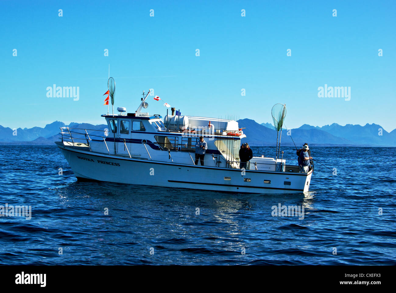 Anglers drift jigging from fishing group party boat rolling in open Pacific  Ocean swells Ucluelet BC Stock Photo - Alamy