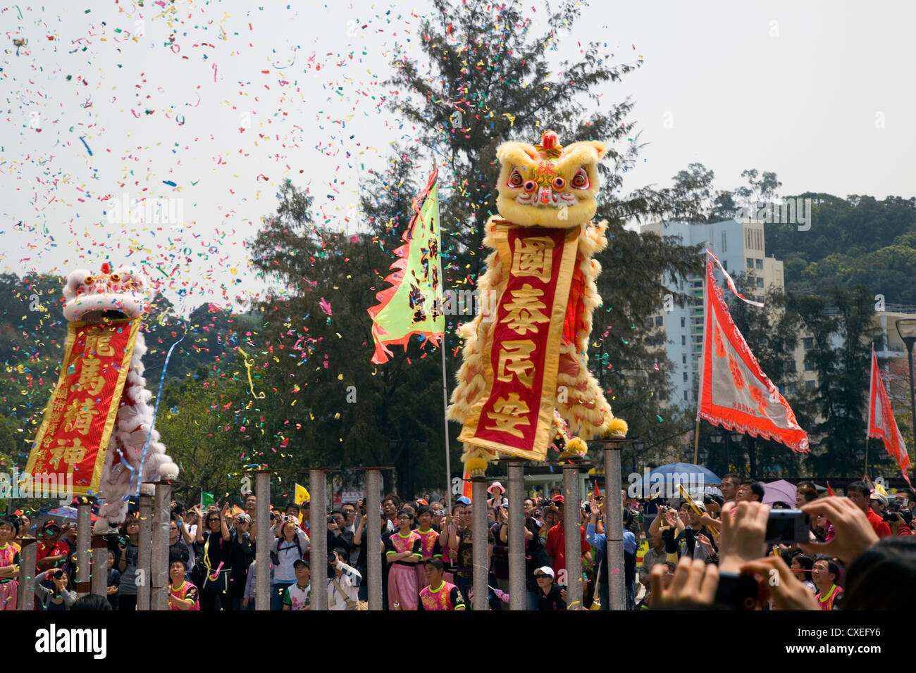 Traditional chinese dragons dance on poles above the ground, Lantau Island, Hong Kong, China. Stock Photo