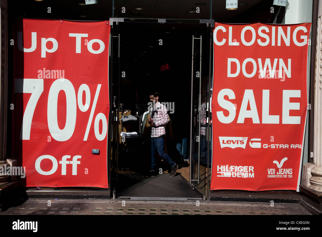 Closing Down Sale signs of a retail shop in central London, UK. Due to the economic downturn, many shops are closing. Stock Photo