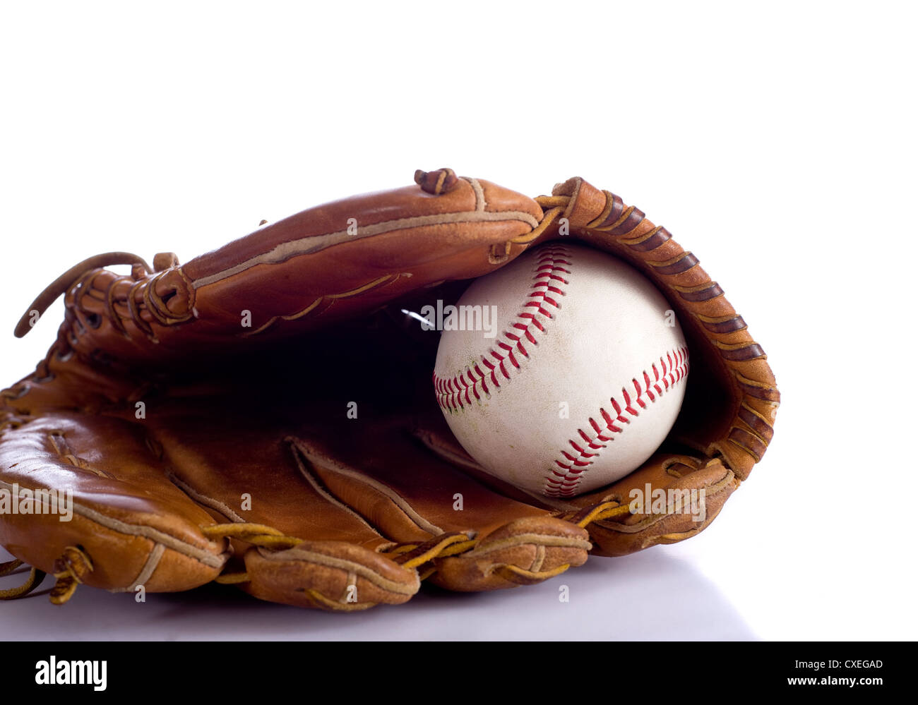 A leather baseball glove and a baseball on a white background with copy space Stock Photo