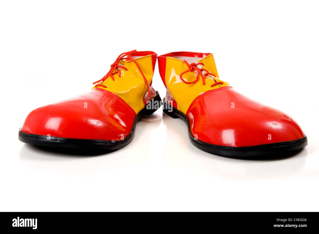 A pair of huge colorful clown shoes on a white background with copy space  Stock Photo - Alamy