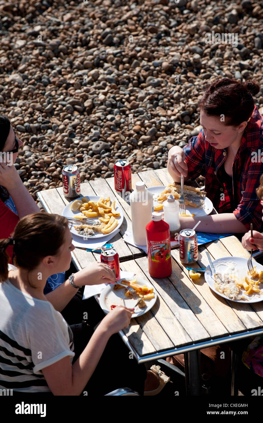 People eating fish and chips on Brighton seafront Stock Photo Alamy