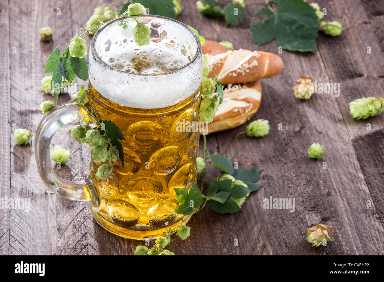 Big mug of Beer with hop on wooden table Stock Photo Alamy