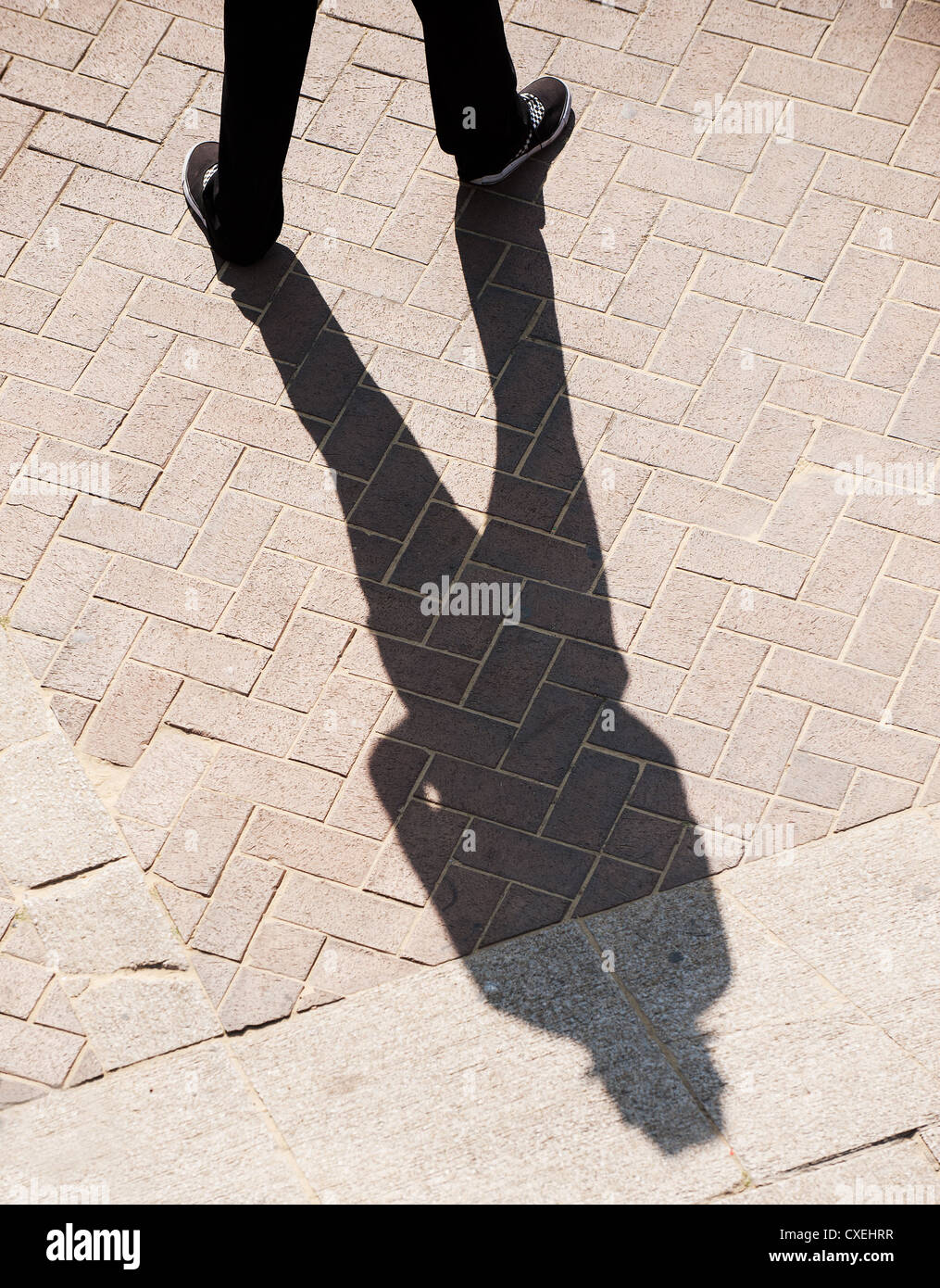 A person casting a shadow on the ground Stock Photo Alamy