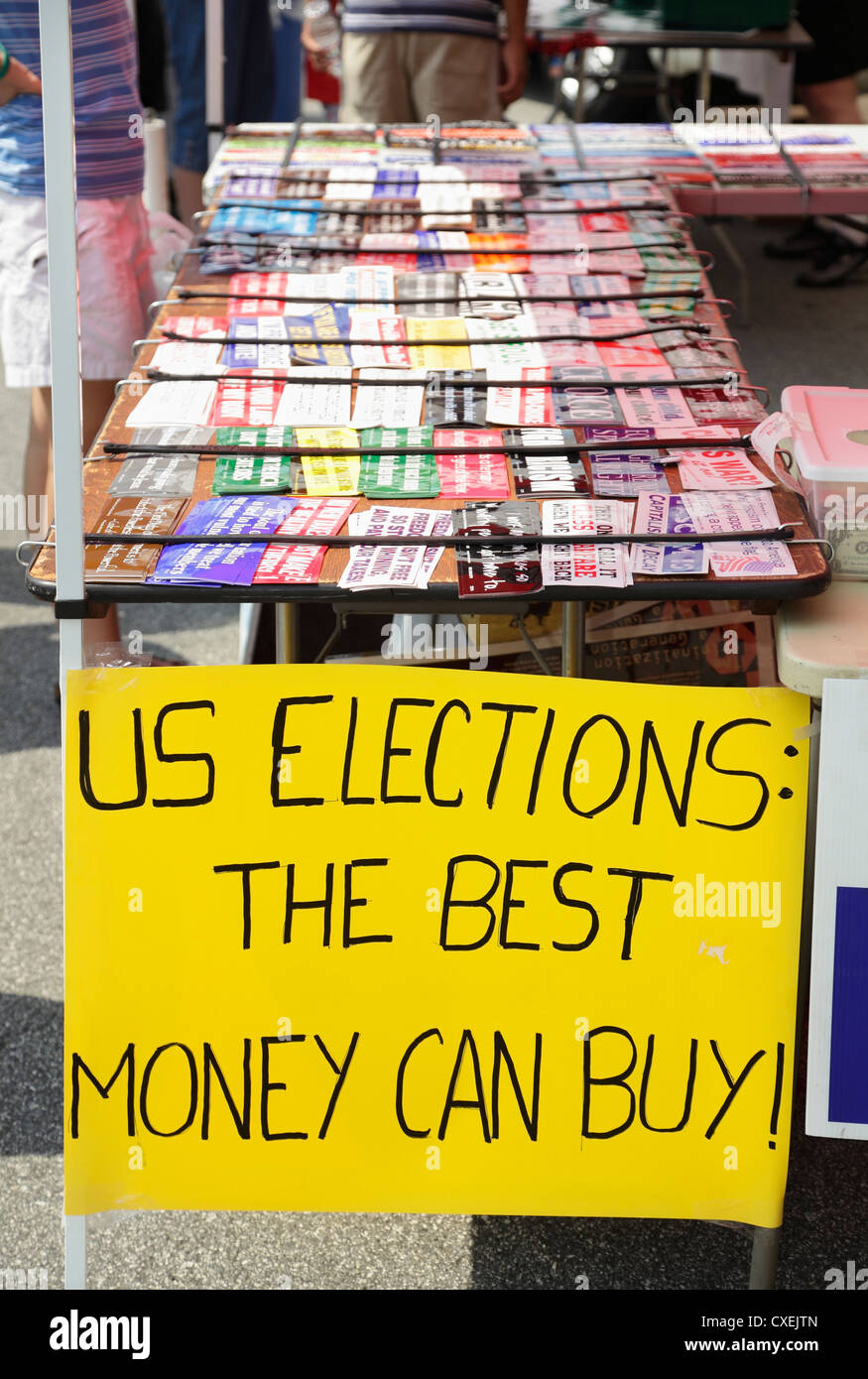 A sign that reads 'U.S. Elections: The Best Money Can Buy' at a booth selling bumper stickers, Greensboro, North Carolina, USA Stock Photo