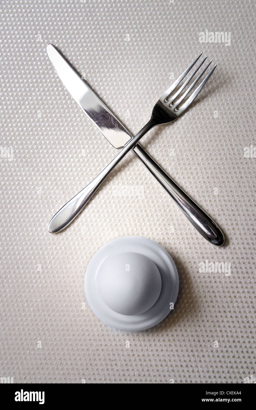 One egg with crossed knife and fork Stock Photo - Alamy