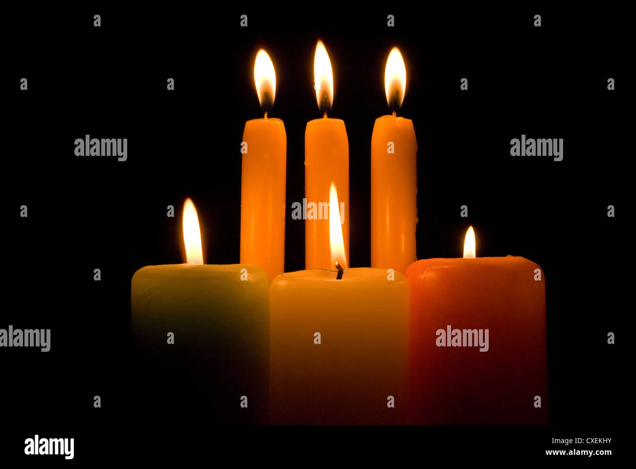 Burning candles over a black background Stock Photo - Alamy