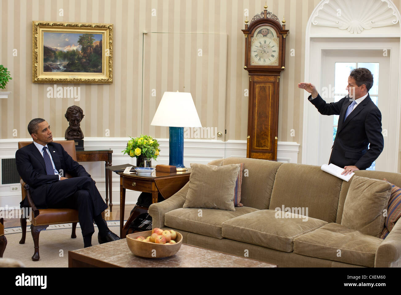 US President Barack Obama listens to Treasury Secretary Timothy Geithner September 29, 2011 in the Oval Office of the White House. Stock Photo