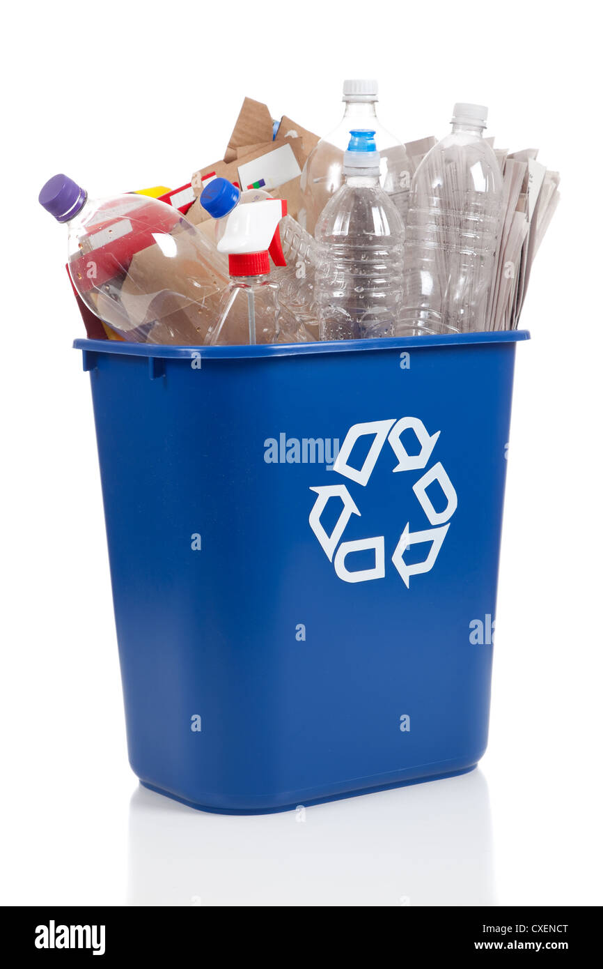 A blue recycling can with cardboard and plastic bottles on a white background Stock Photo