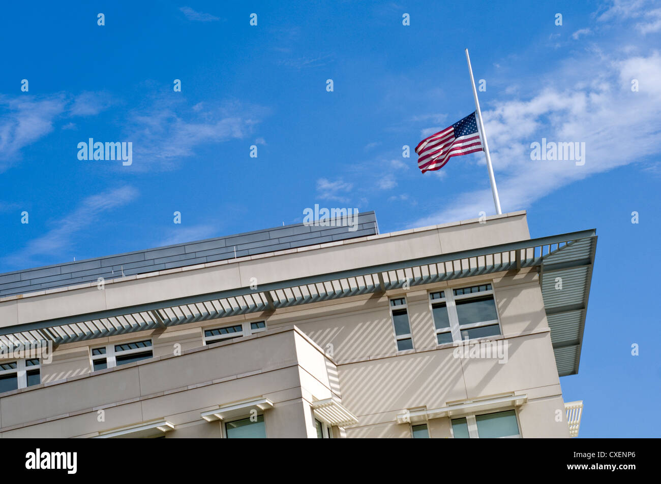 The American flag flying at half mast over the US Embassy in Berlin, Germany Stock Photo