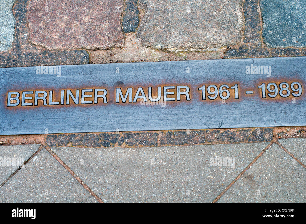 Pavement plaque near Checkpoint Charlie indicating the original site of the Berlin Wall. Stock Photo