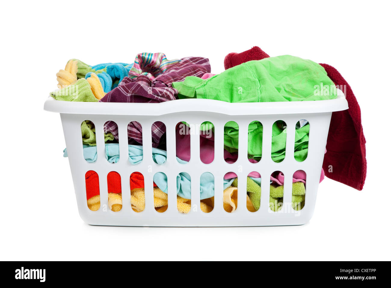 White plastic laundry basket full of dirty clothes Stock Photo