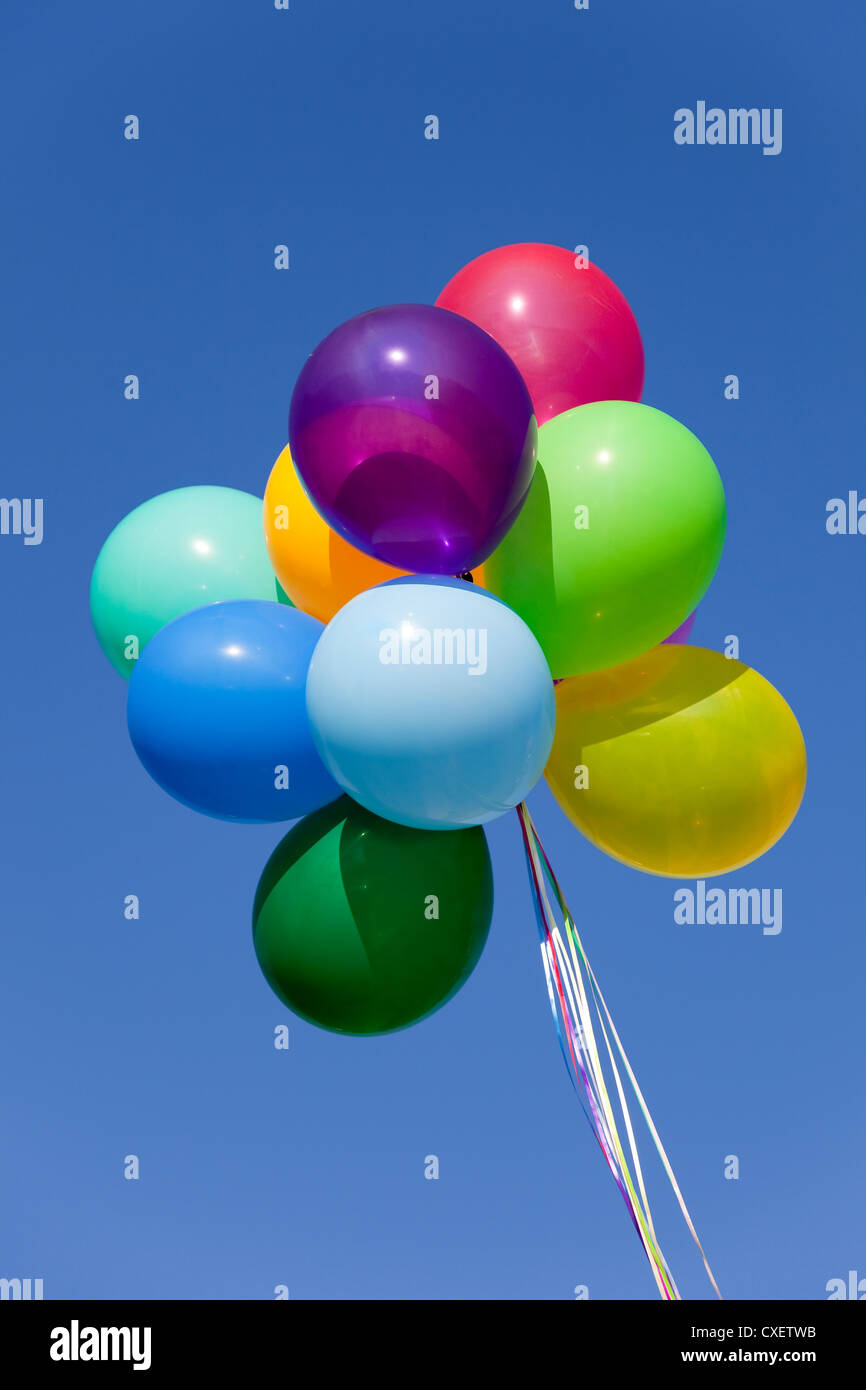 Bouquet of multicolored balloons with a blue sky background Stock Photo