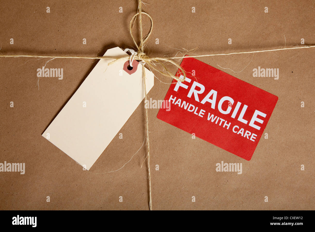 A brown shipping box with a blank tag and a fragile sticker with copy space Stock Photo