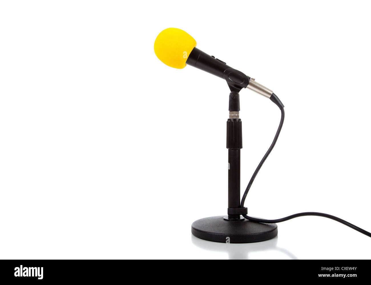 Microphone on a small black stand with a yellow cover Stock Photo