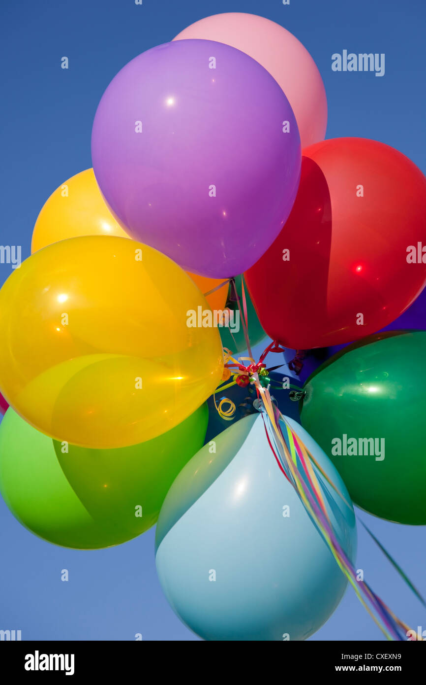 Group of assorted balloons white a blue sky background Stock Photo