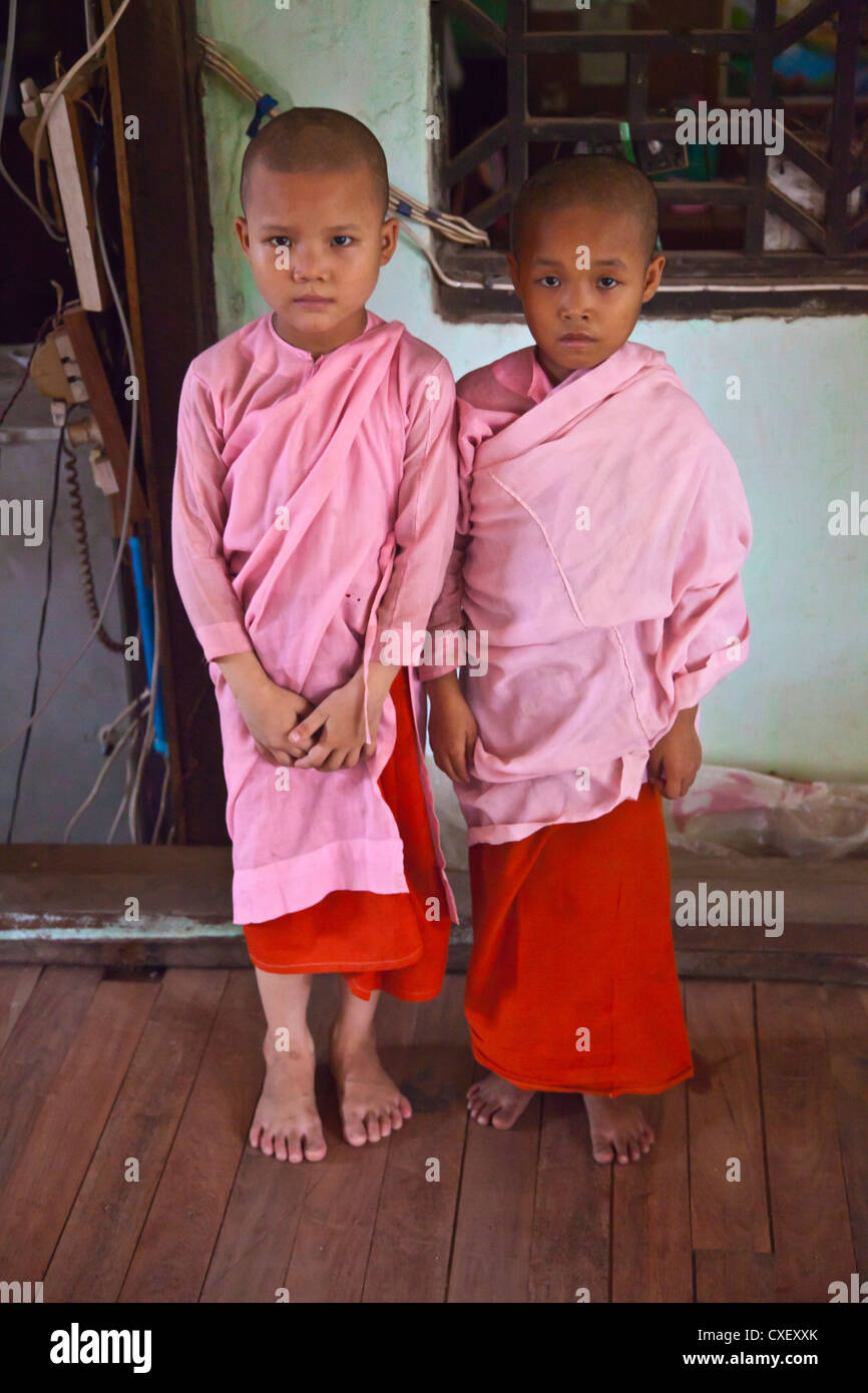 Young NUNS at a BUDDHIST ORPHANAGE - BAGO, MYANMAR Stock Photo