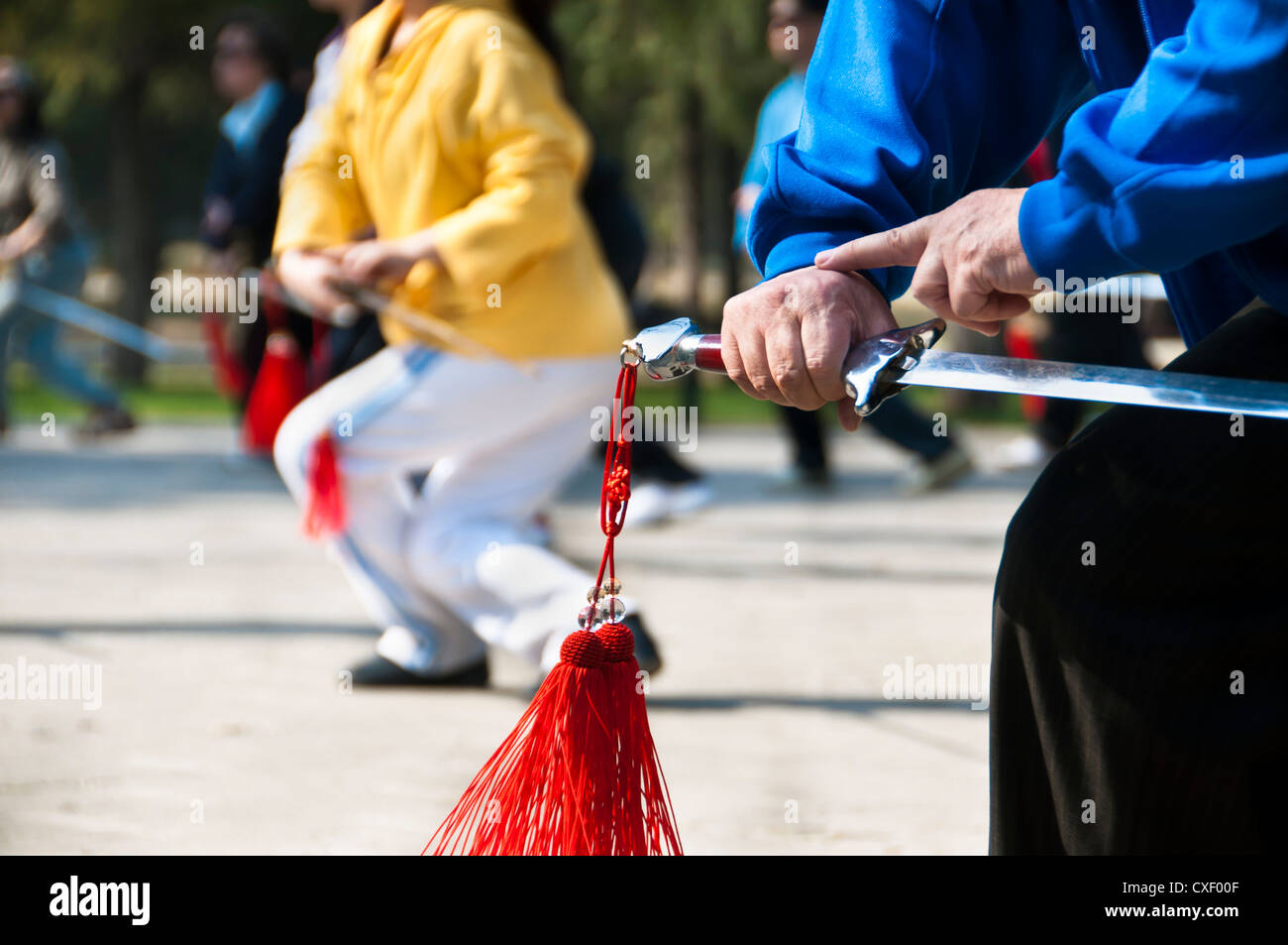 Locals practice with tai chi swords in the Temple of Heaven park, Beijing Stock Photo