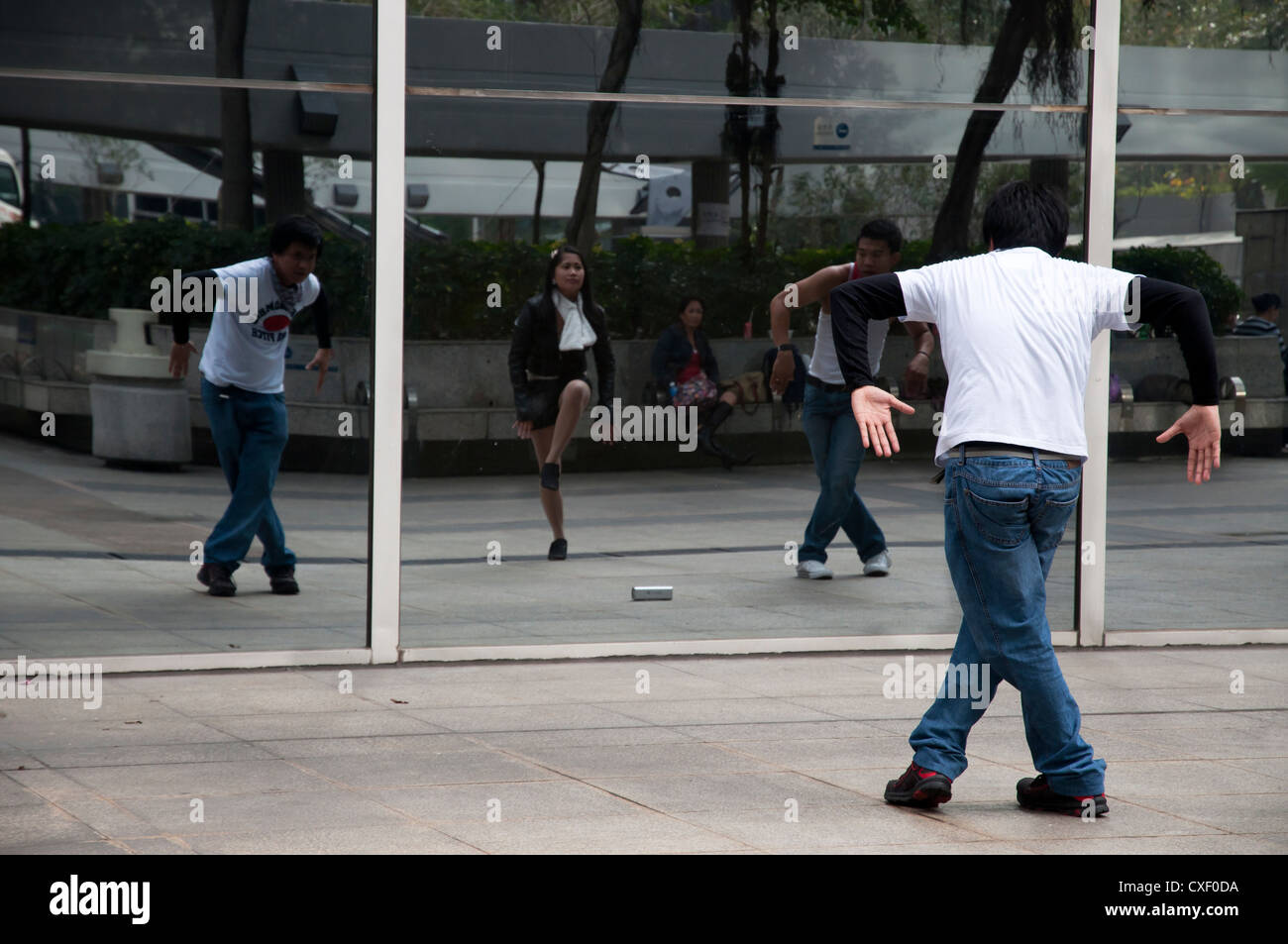 Young Filipinos practice their dancing outside Immigration Tower, Hong Kong Stock Photo