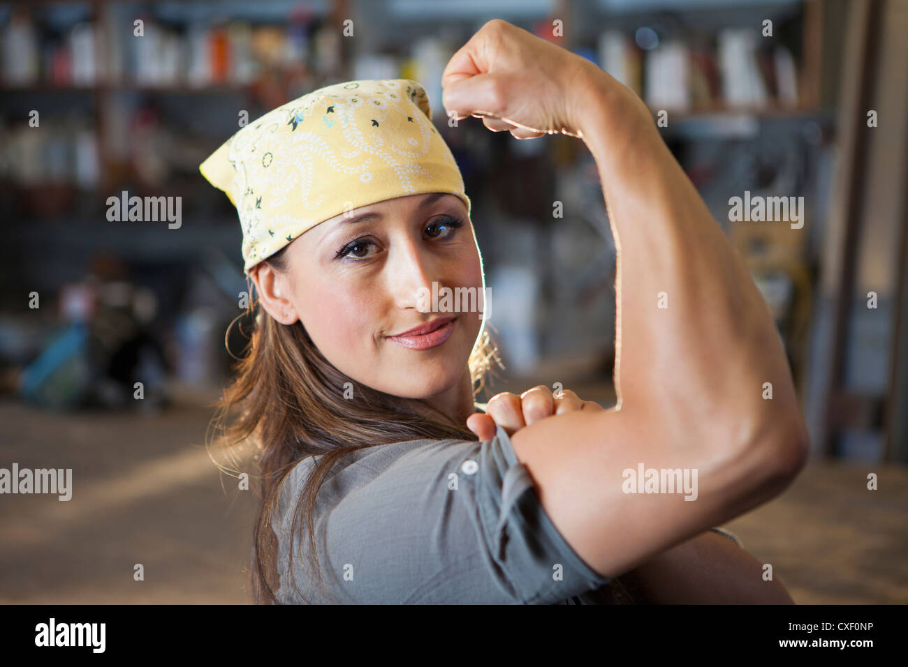 Hispanic worker flexing biceps Stock Photo