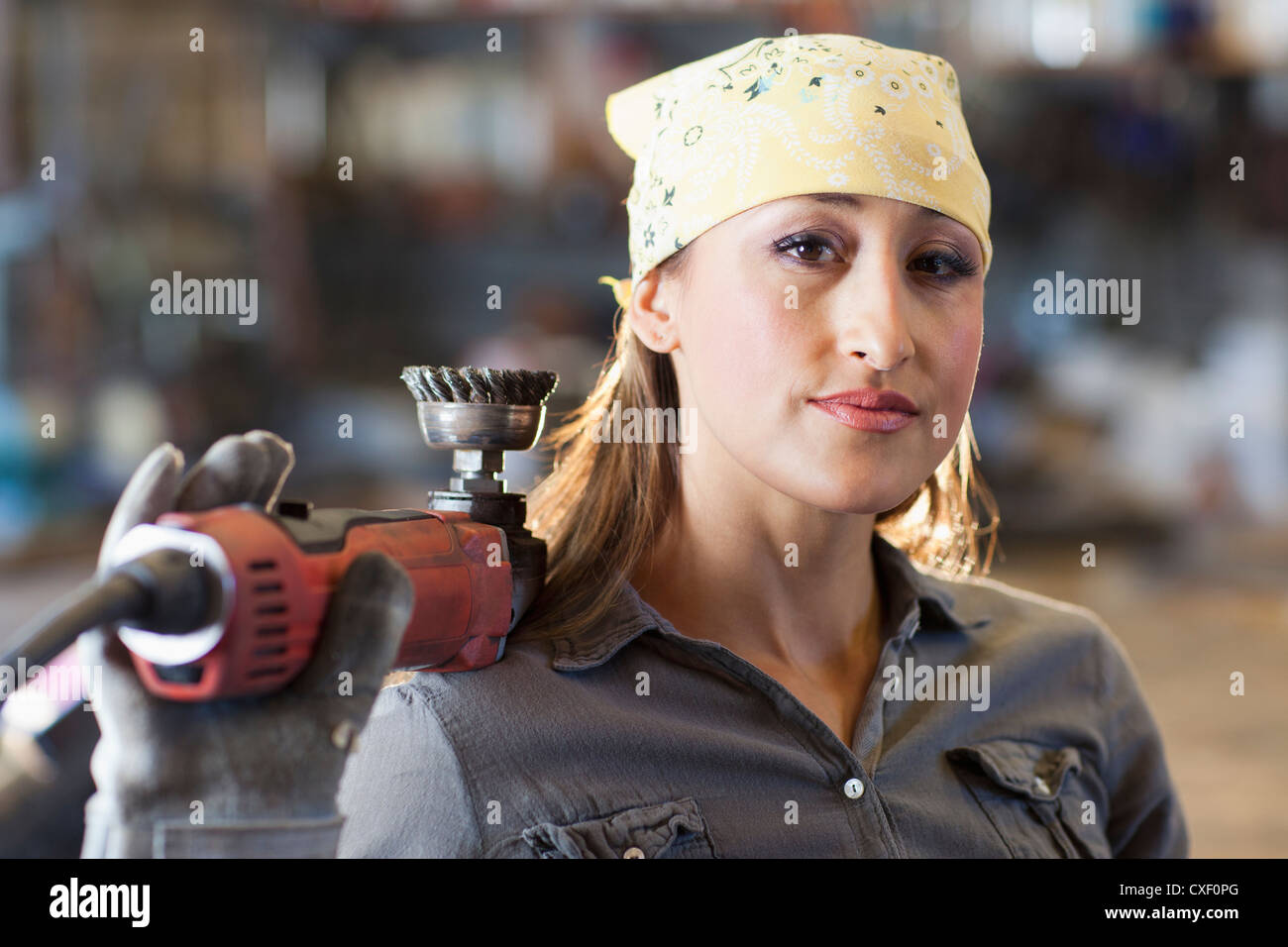 Hispanic factory worker holding metal fabricator Stock Photo