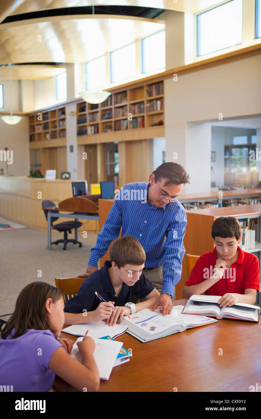 Helping student students hispanic ethnic asian girls hi-res stock ...