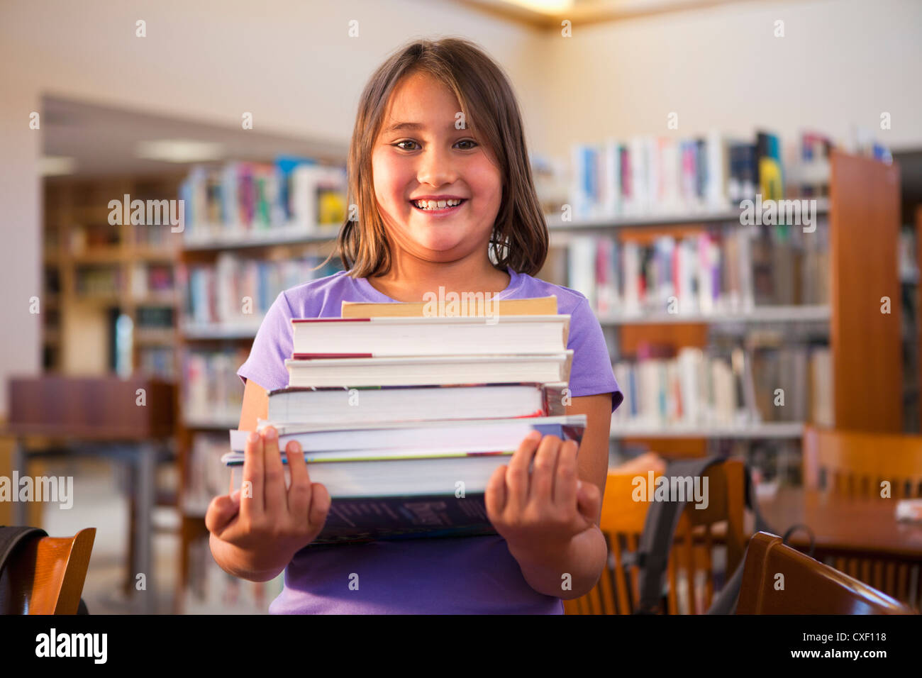 Girl standing on stack books hi-res stock photography and images - Alamy