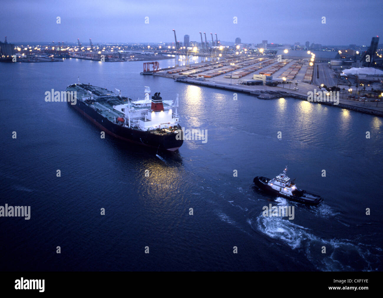 Tugboat and container ship in the port of Long Beach Stock Photo