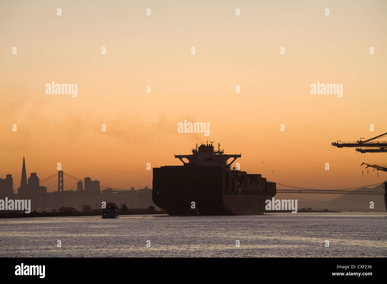 Tugboat and container ship in port of Oakland Stock Photo