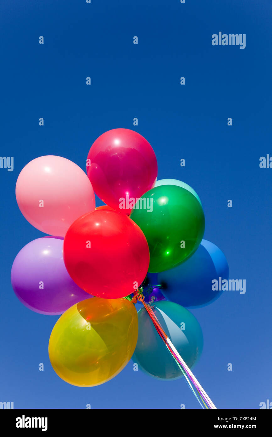 Group of multicolored balloons with a blue sky background Stock Photo