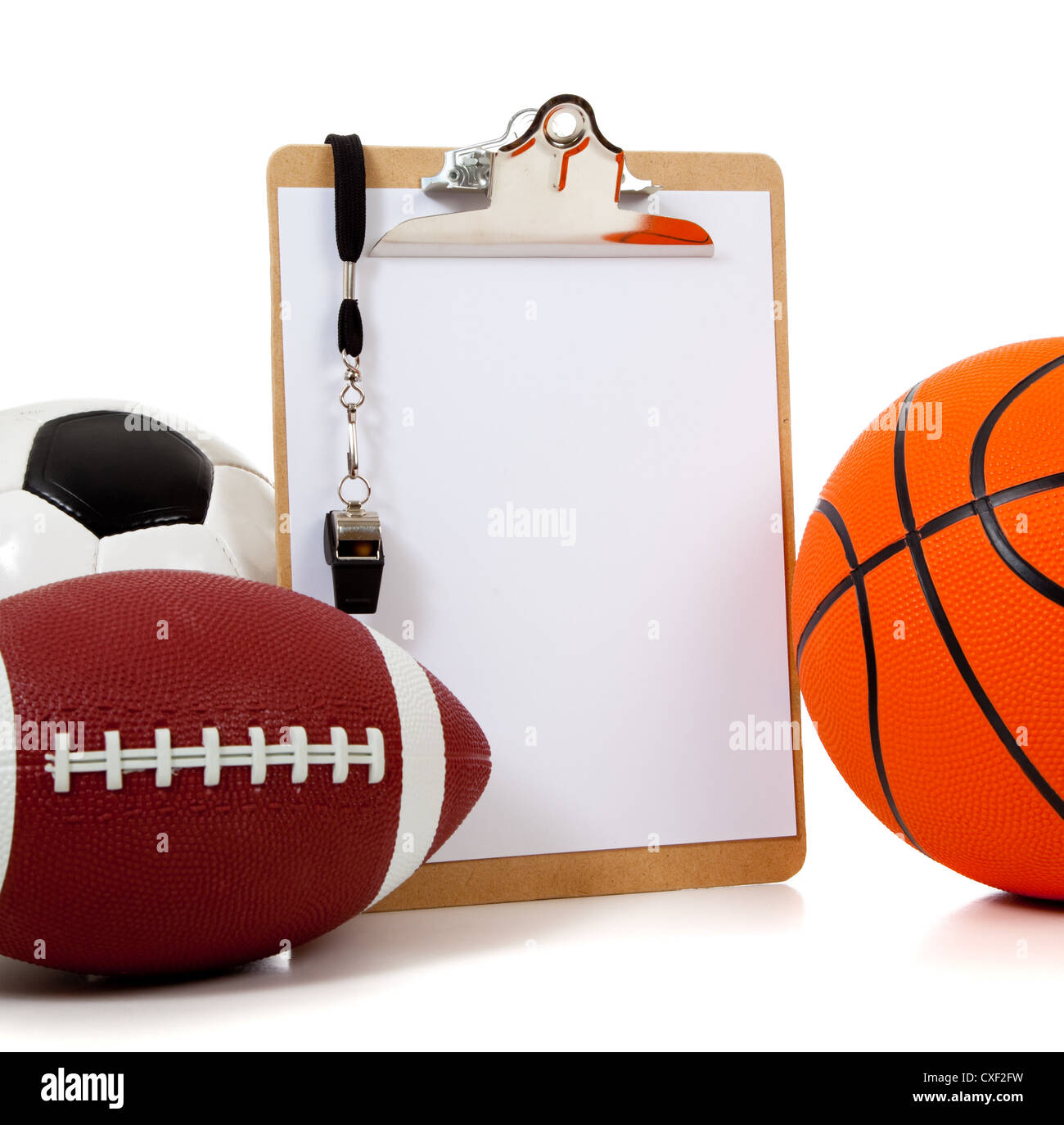 A group of sports ball with a blank clipboard including a basketball an American football and a soccer ball on white Stock Photo