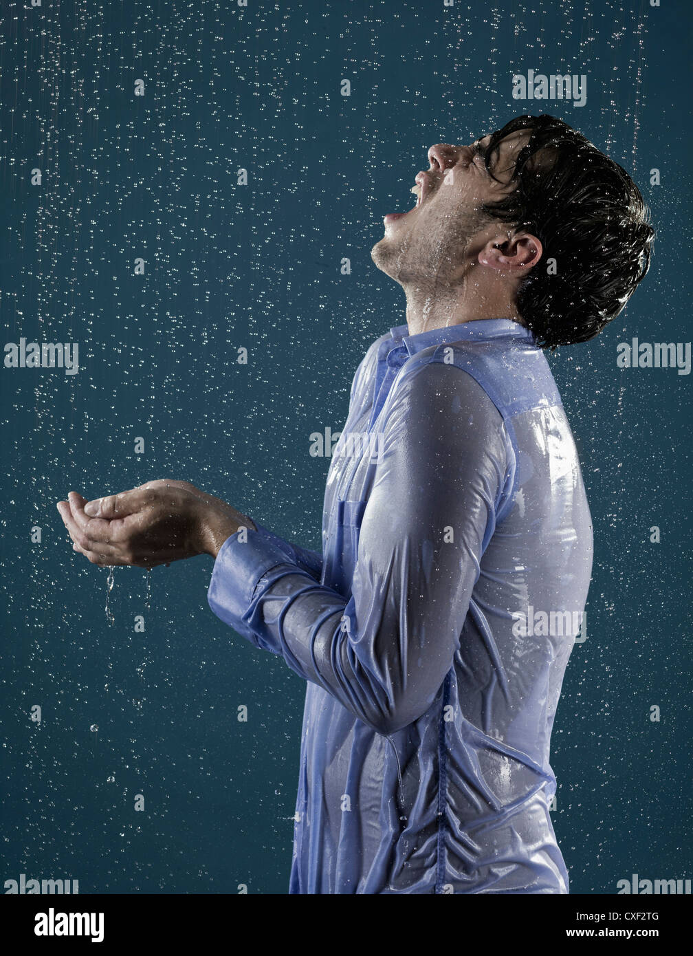 Caucasian man taking a shower in clothing Stock Photo