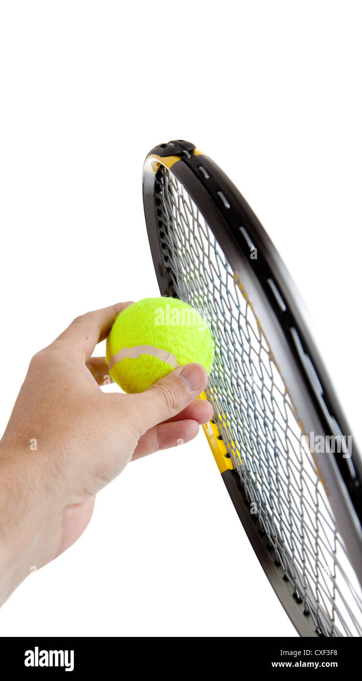 Tennis racket and a hand holding a yellow tennis ball on a white background Stock Photo