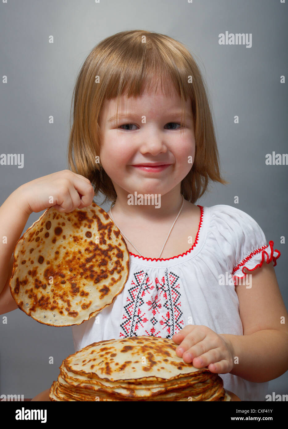 little girl eats pancakes Stock Photo Alamy