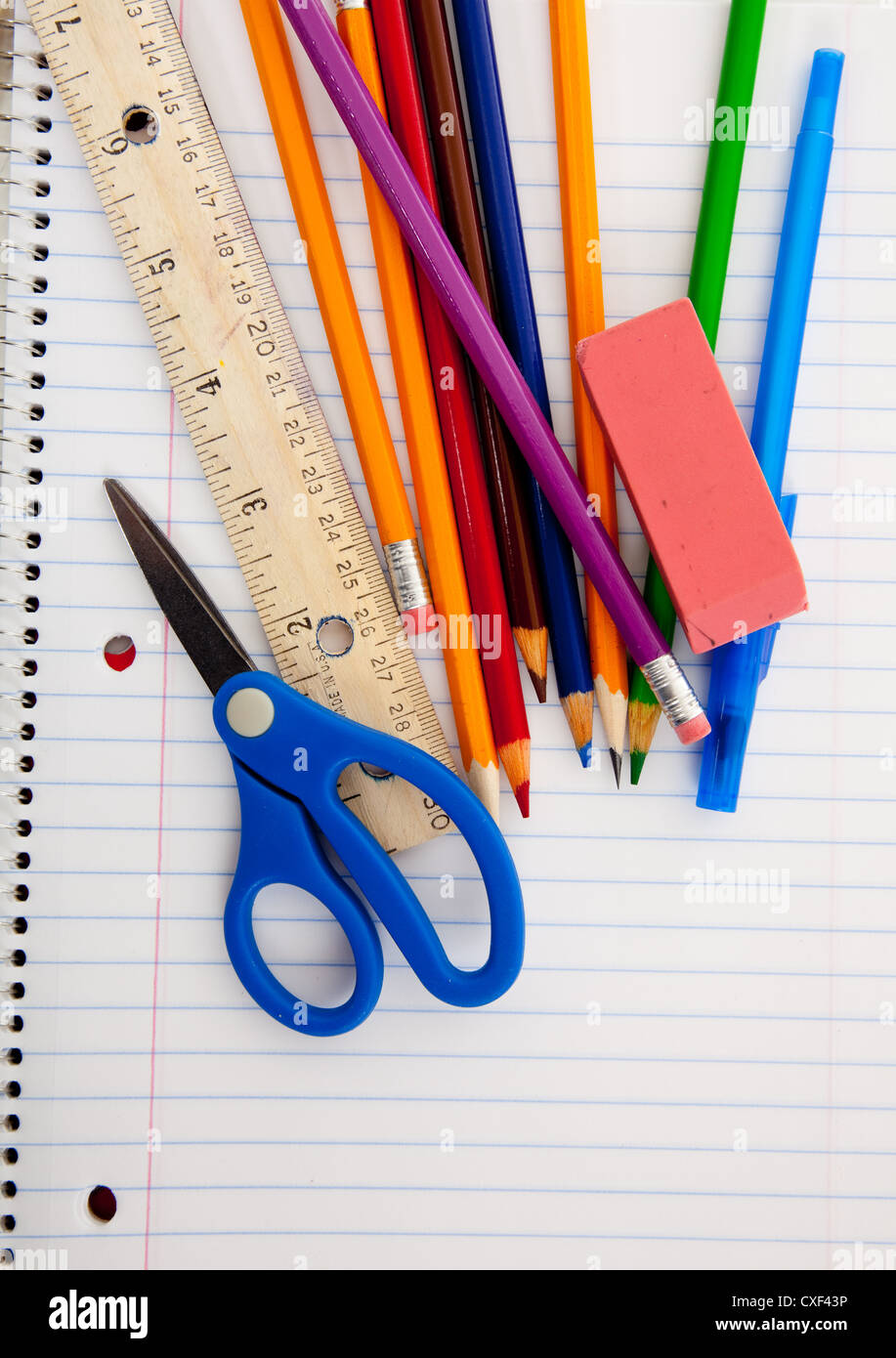 Spiral notebook with pencils and school supplies Stock Photo