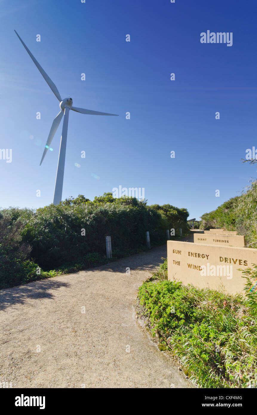 Wind turbine against a blue sky with sun rays on the plaque engraved - Sun energy drives the wind -  Albany, Western Australia Stock Photo