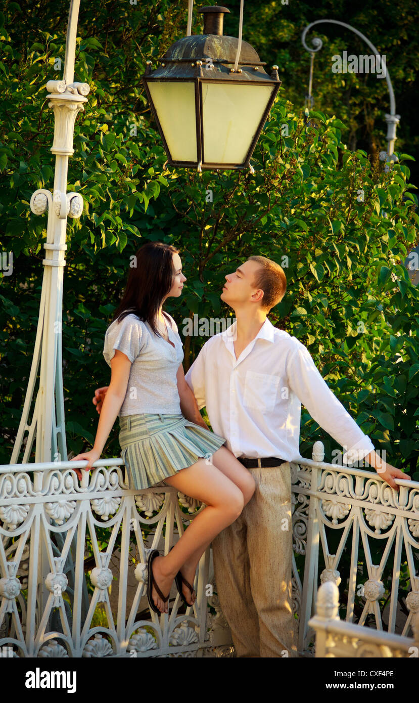 couple in a park under old streetlamp Stock Photo
