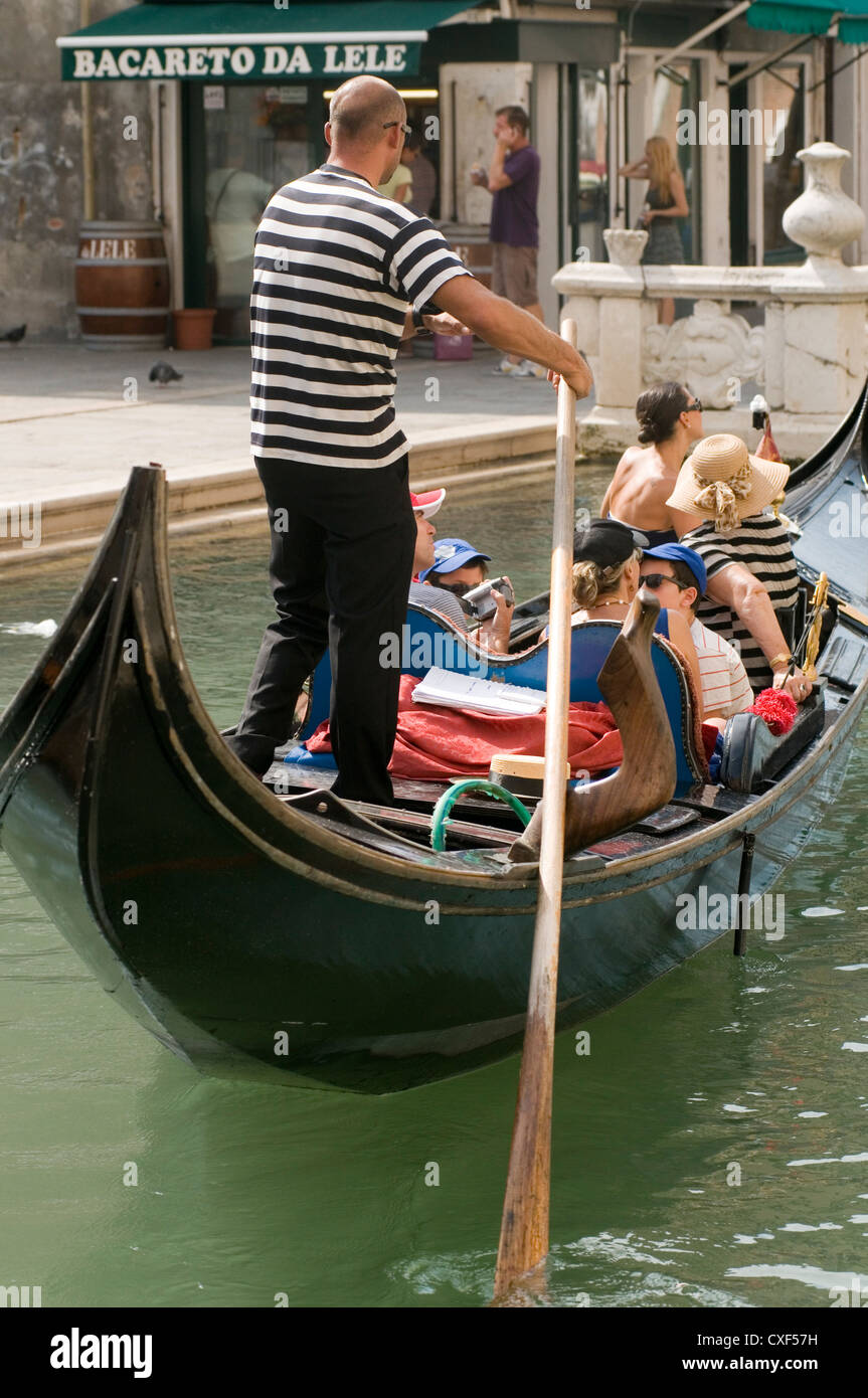 venice gondola ride tourists tourist gondolas canal canals Stock Photo