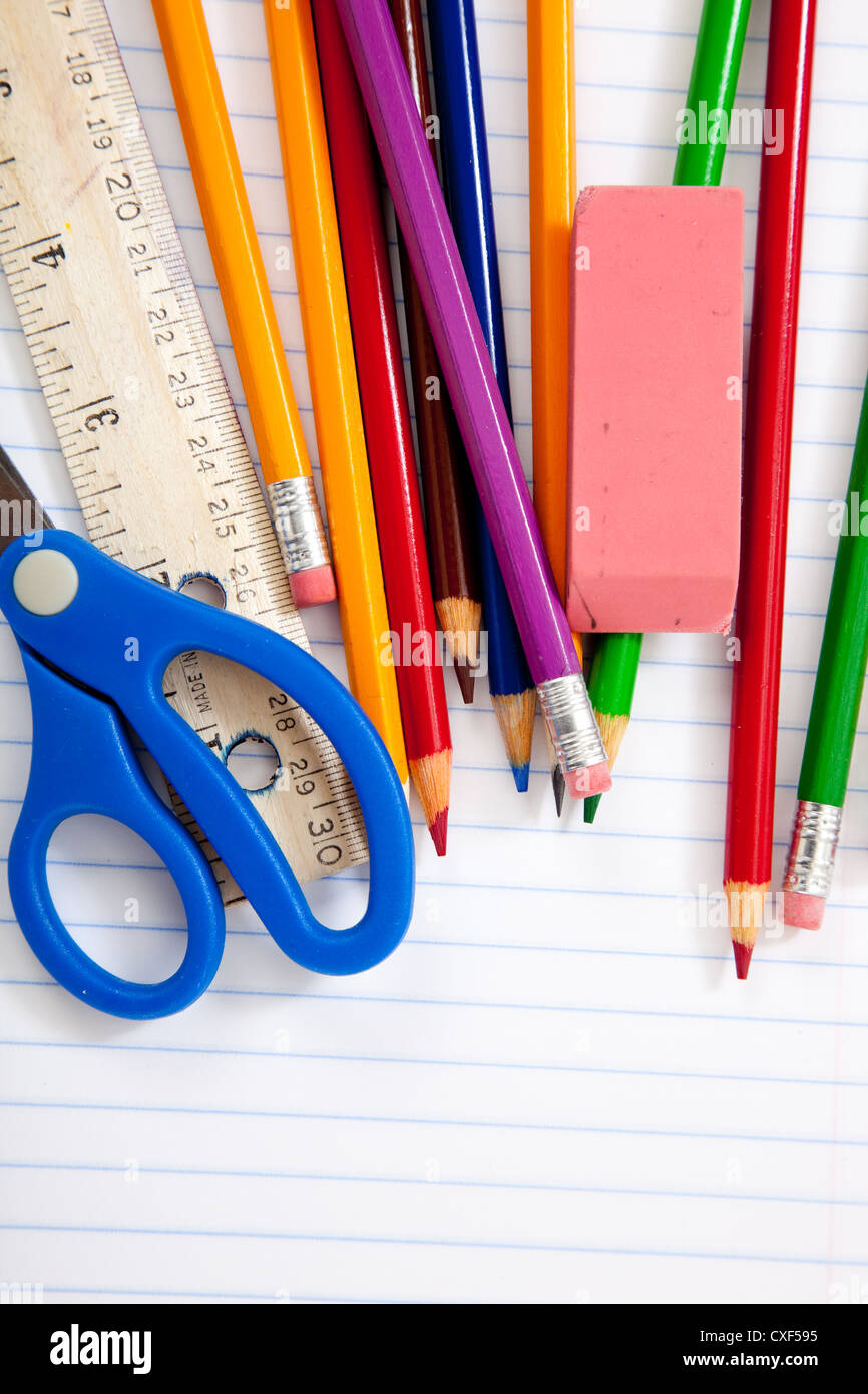 Multi-colored pencils on notebook paper Stock Photo