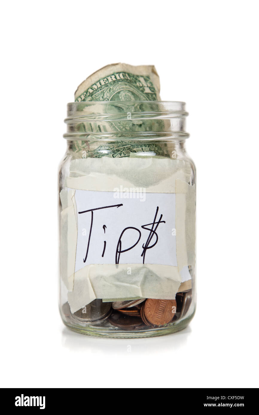 Tip jar with money in it Stock Photo - Alamy