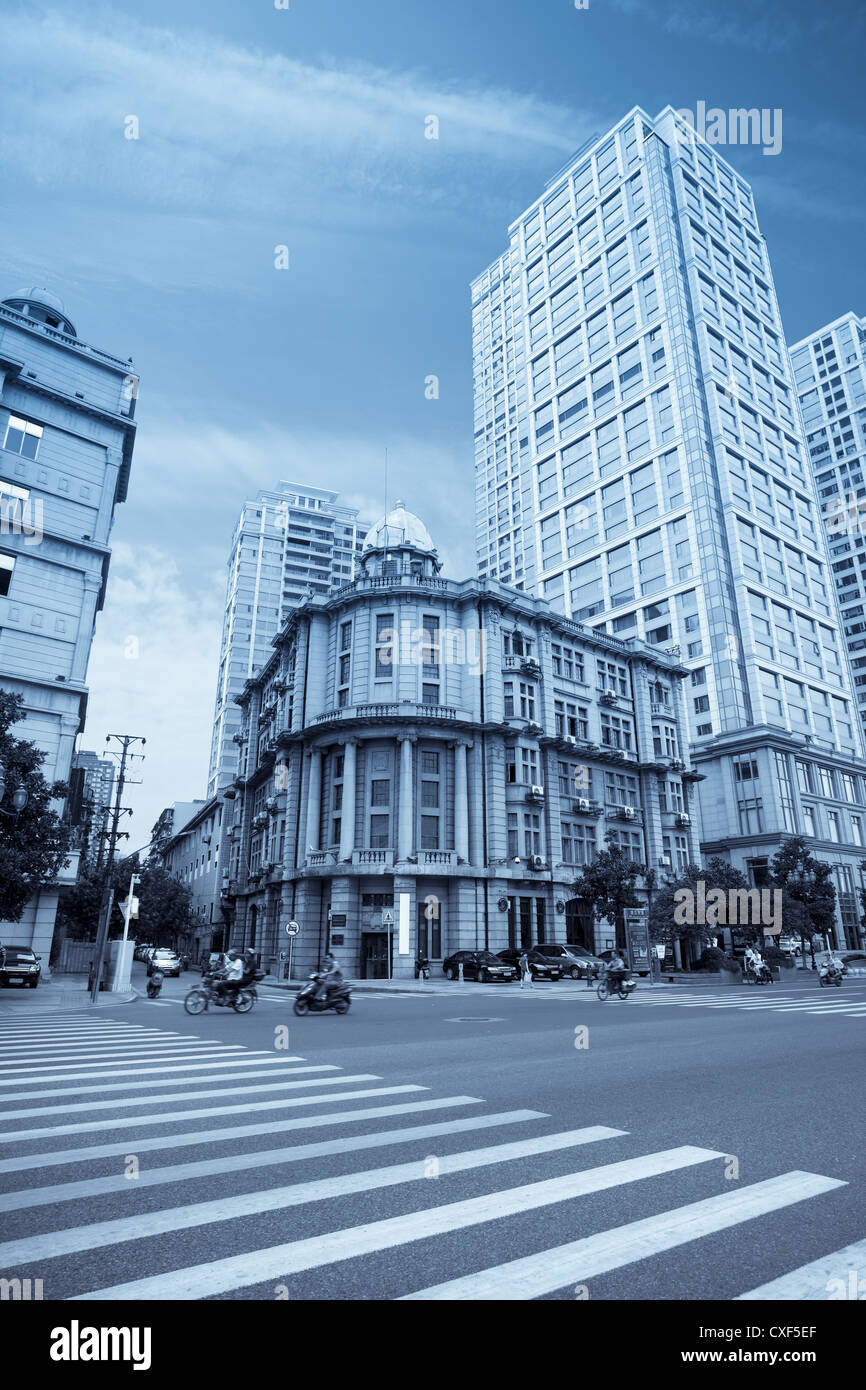 an old building in between modern buildings Stock Photo