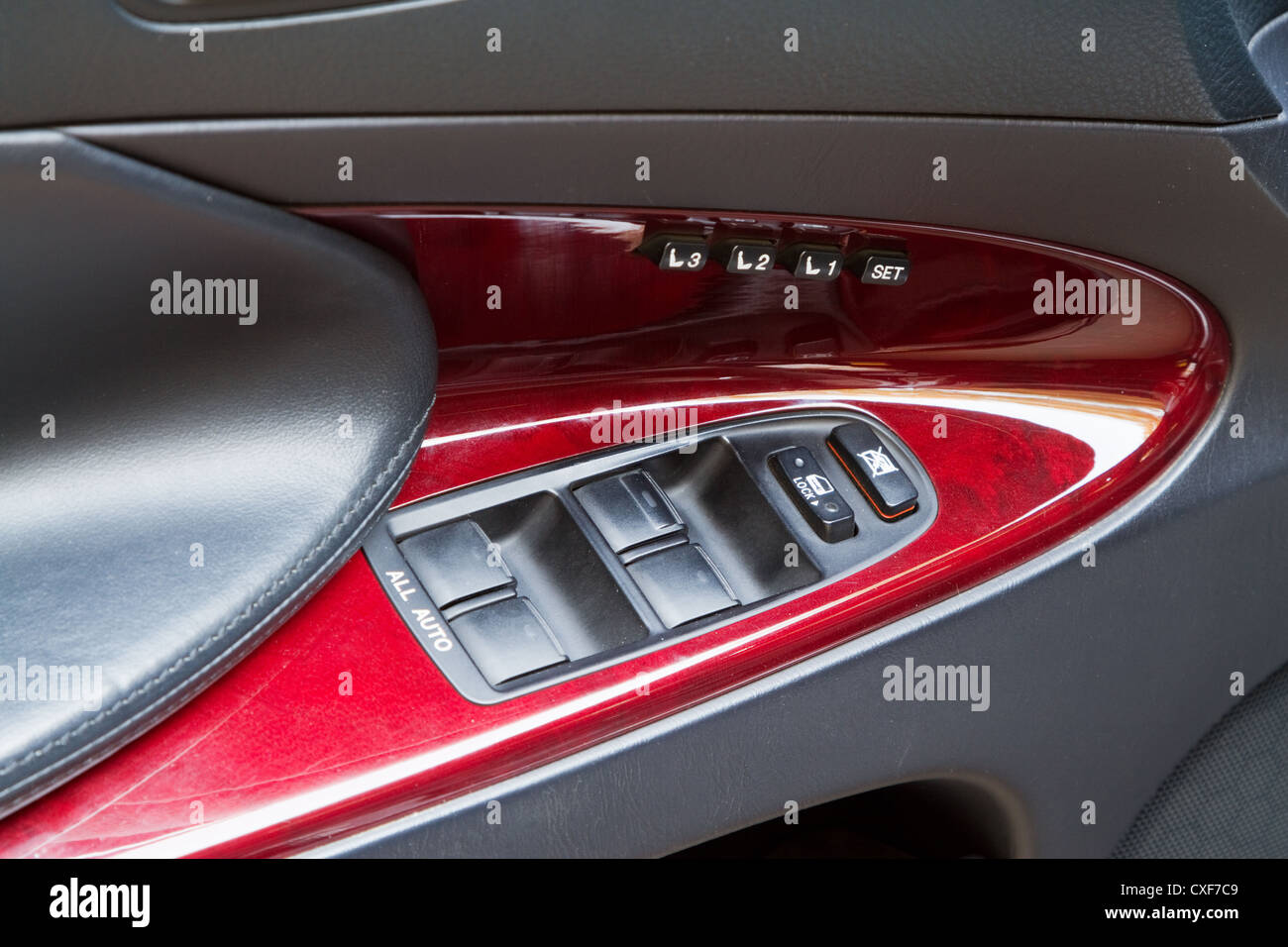 Control knobs in a luxury car, in mahogany finish Stock Photo Alamy