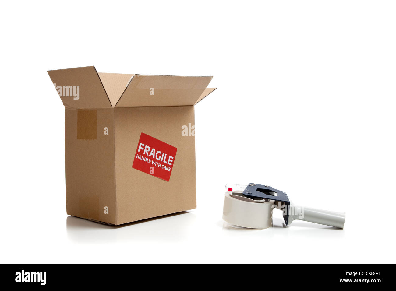Shipping box with fragile sticker and tape gun Stock Photo