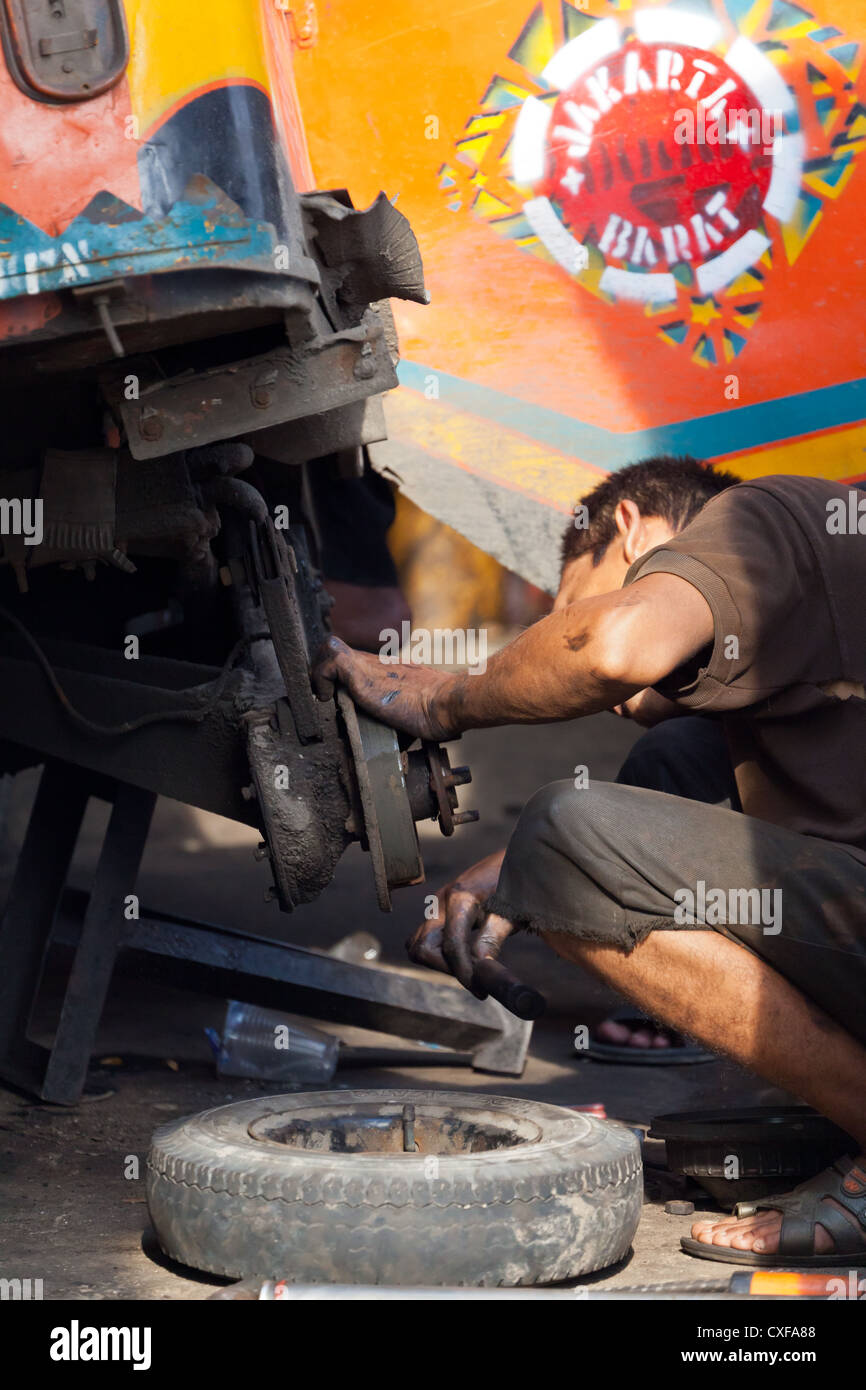 Car Repair in the Streets of Jakarta Stock Photo