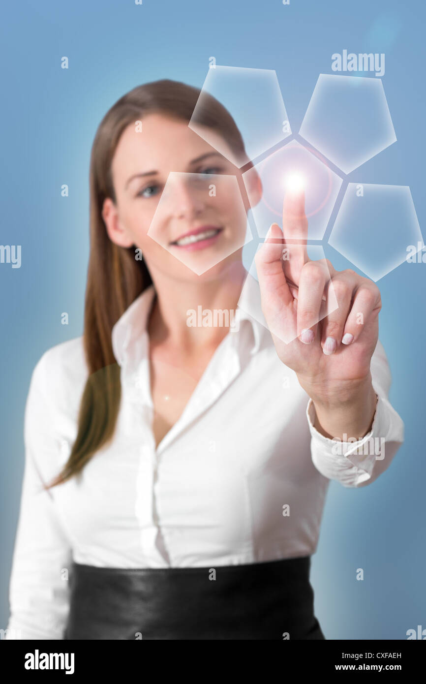 Attractive Brunette Woman Pressing Virtual Button with a light blue background Stock Photo